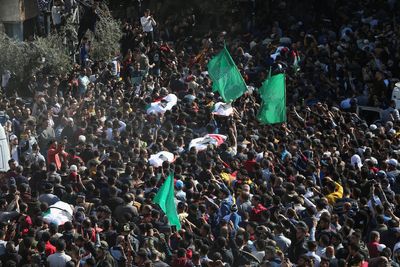 Palestinians bury 21 people killed in Gaza fire