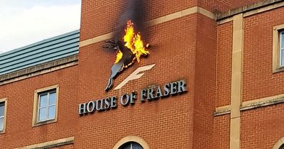 Nottingham House of Fraser sign catches fire before falling into street