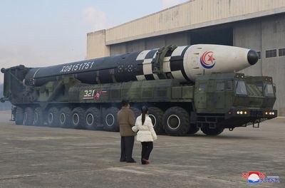 North Korea's Kim reveals daughter at ballistic missile test