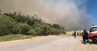 Containment lines keep Fullerton Cove fire under control