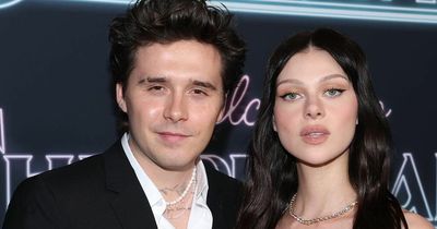 Doting Brooklyn Beckham carries Nicola Peltz to their car after night with in-laws