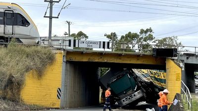 Truck jams under low rail bridge on Oxley Road at Corinda for second time in a week