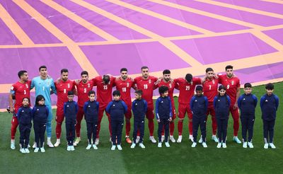 Soccer-Iran World Cup players silent as anthem plays, signalling protest support