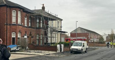 'Slates hurled at cars' as man climbs on roof and 'demands money'