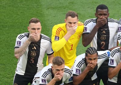Germany players cover mouths at World Cup in FIFA protest