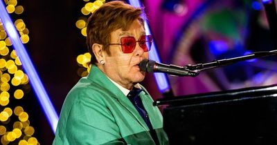 Elton John delights Christmas shoppers as he performs festive song in shop window