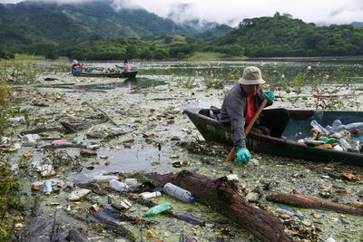 No place for flowers: El Salvador's biggest lake swamped by trash