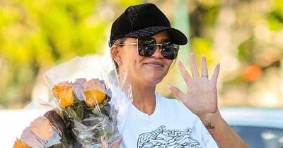 Pregnant Chrissy Teigen beams as she showcases blossoming baby bump in cropped T-shirt