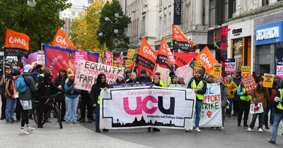 Striking university staff march through Liverpool in row over pay and conditions