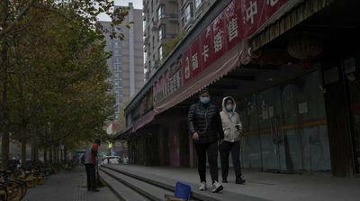 China Reports New Daily Record COVID Cases, Curbs Tighten across Country