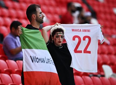 Security escort man wearing pro-Iran protest shirt ahead of match