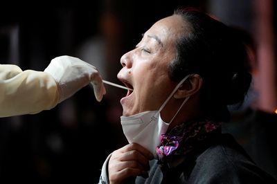 China orders lockdowns, mass testing after record COVID surge