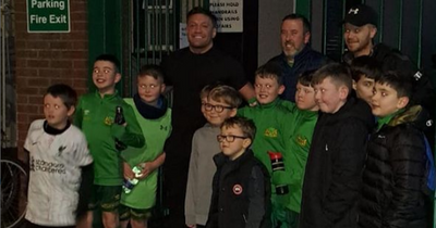 Conor McGregor poses for pictures with fans on visit to boyhood football club