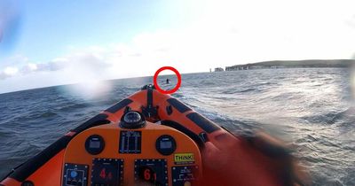 Terrifying moment paddleboarder is rescued after strong winds blew her off-shore