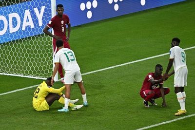 Hosts Qatar knocked out of World Cup as England made to wait