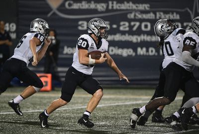 New Hampshire players high-five during 87-yard touchdown play