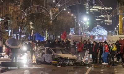 Rioters torch a car in Brussels after Belgium’s World Cup defeat to Morocco