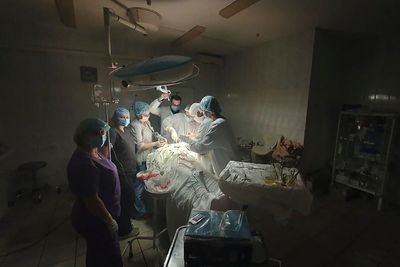 Surgeons work by flashlight as Ukraine power grid battered