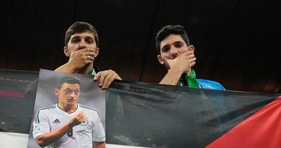 World Cup fans respond to Germany protest by holding up pictures of Mesut Ozil