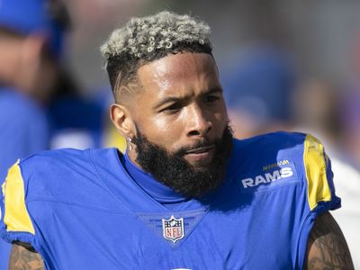 NFL wide receiver Odell Beckham Jr. is escorted off a plane in Miami