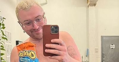 Sam Smith enjoys some Cheetos in NYC as they show off brand new tattoos in topless snap