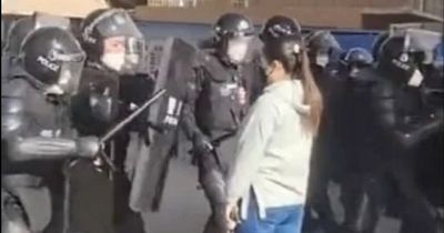 Chinese girl defiantly stands in front of riot cops and is dubbed ‘tank lady’