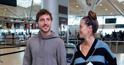 Seann Walsh looks loved-up with pregnant girlfriend as they arrive at airport