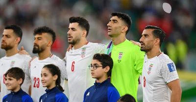 Iran players sing national anthem after being told 'families face prison or torture'
