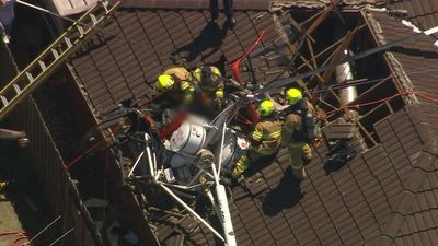Helicopter crashes into Mentone home in Melbourne's south-east, trapping pilot