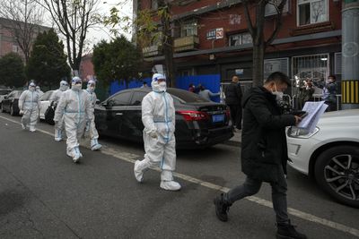 Record wave of COVID infections sparks more curbs across China