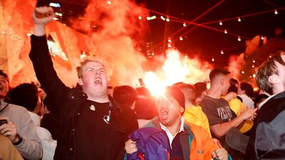 Federation Square erupts as Melbourne football fans celebrate Australia's World Cup win over Denmark