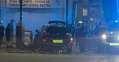 Emergency services called after car smashes through barrier on main road