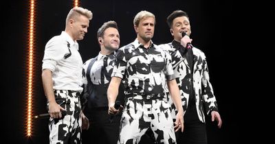 Westlife perform with cardboard cut-out of Mark Feehily as he battles illness in hospital
