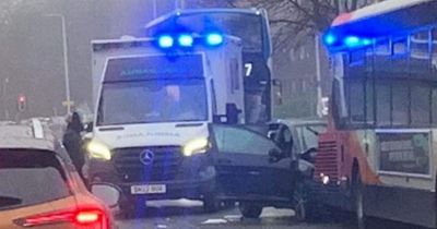 Child among three people rushed to hospital as car crashes into bus on busy Scots road