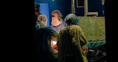 Medics pictured forced to use mobile phone torches in surgery during Ukraine blackouts