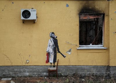 People try to steal Banksy mural of gas-masked woman in Ukraine