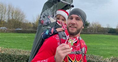 Dad runs races with daughter, 2, on his back and even manages to complete half marathon