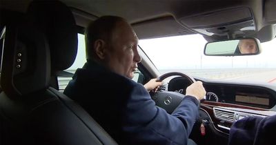 Vladimir Putin brazenly drives across repaired Crimea bridge after huge truck bomb