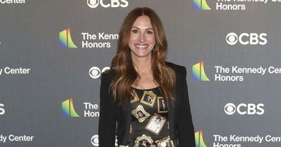 Julia Roberts pays homage to pal George Clooney with dress covered in photos of his face