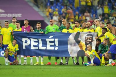 Brazil players display banner in support of Pele after seeing off South Korea