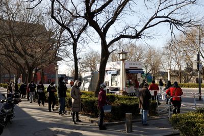Beijing drops COVID testing burden as wider easing beckons