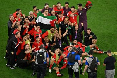 Morocco players celebrate with Palestinian flag after Spain upset