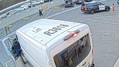 Armed man shot after entering California police station lot