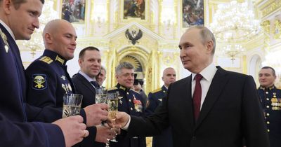 Vladimir Putin guzzles champagne as he blames Ukraine for Russian's military strikes