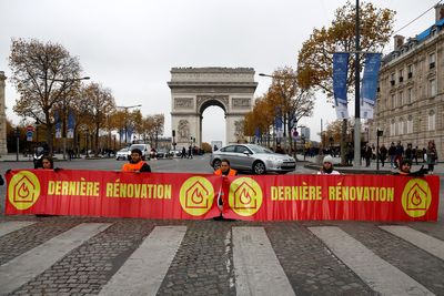 Climate activists block Champs Elysees to demand better insulation of buildings
