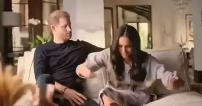 Meghan Markle accused of 'mocking' The Queen in awkward Netflix moment as Prince Harry looks on