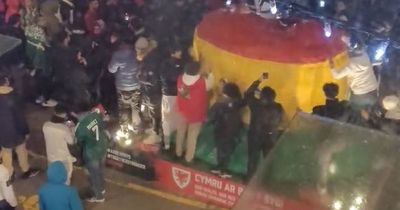 Jubilant Morocco fans climb on giant Welsh bucket hat as they celebrate historic World Cup win over Cristiano Ronaldo's Portugal