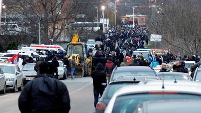 Kosovo police exchange gunfire with local Serbs blocking roads to protest officer's arrest