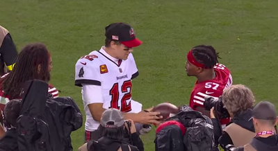 Tom Brady happily signed a ball Dre Greenlaw intercepted after his loss to the 49ers