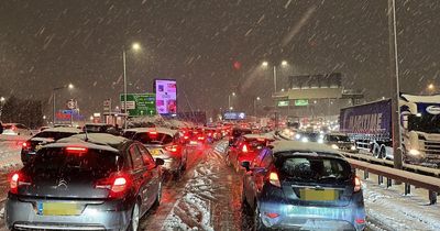 Motorist builds life-size snowman in middle of busy road after getting trapped